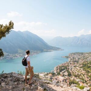 Hiker on mountain looking away at elevated view of sea, Kotor, Montenegro, Europe