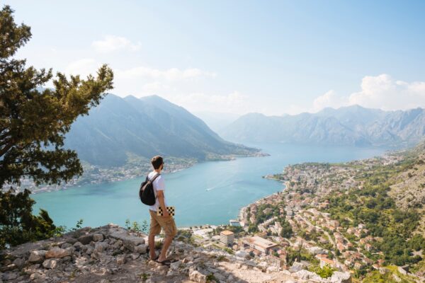 Hiker On Mountain Looking Away At Elevated View Of Sea, Kotor, Montenegro, Europe