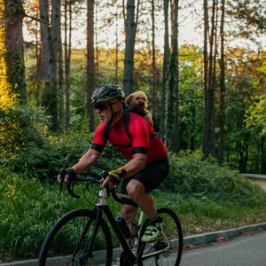 Senior man cycling with his puppy